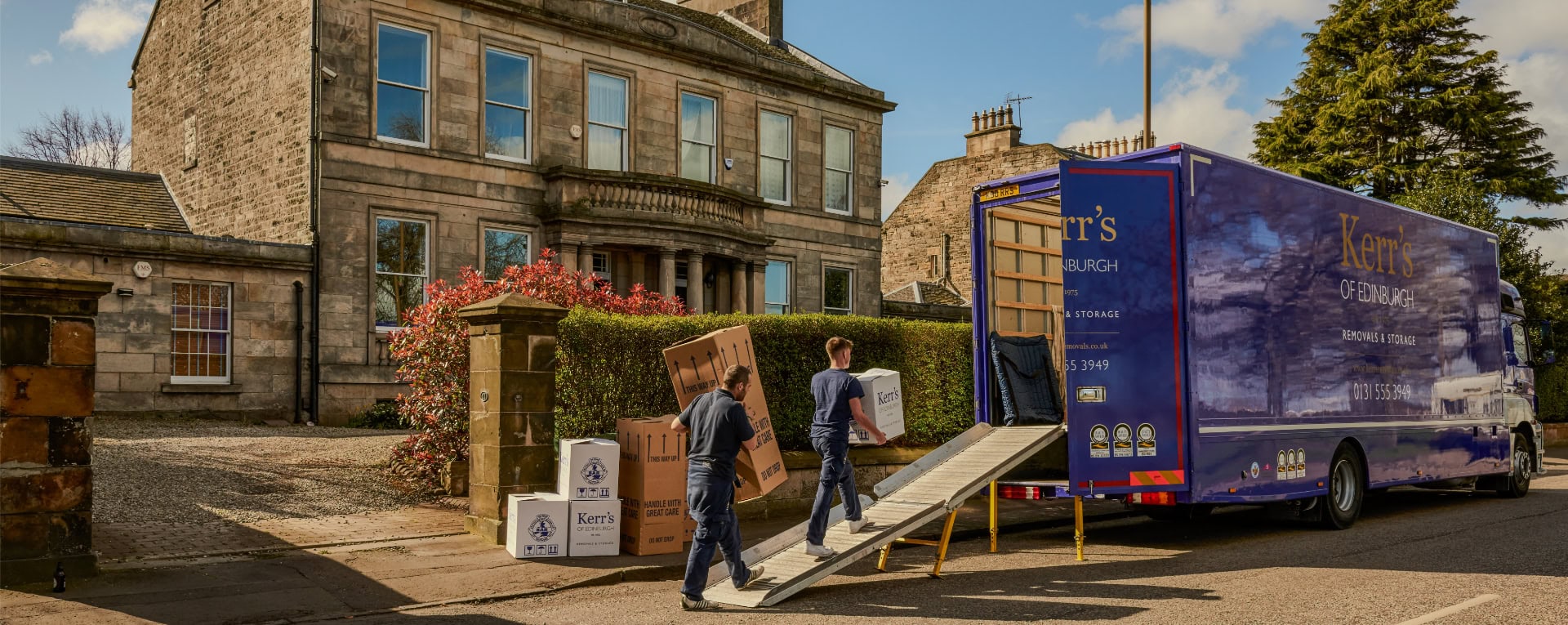 Kerr’s Removals team loading branded boxes into a van outside a Georgian property in Edinburgh